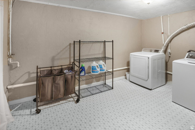 5108 South 2000th Street West Roy, UT 84067 - Photo 43 of 61 Laundry area with separate washer and dryer and a textured wall