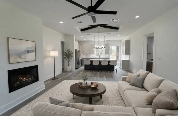 a large kitchen with a large counter top a sink a stove and a chandelier