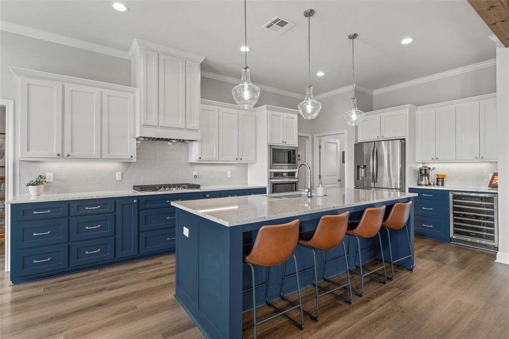 624 Lindsay Lane Robinson, TX 76706 - Photo 11 of 39 a large kitchen with kitchen island granite countertop a table chairs sink and cabinets