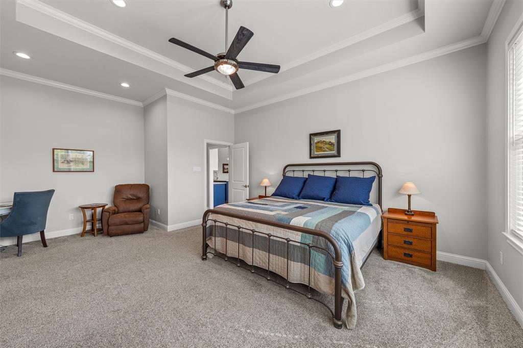 624 Lindsay Lane Robinson, TX 76706 - Photo 21 of 39 a bedroom with a bed and a chandelier