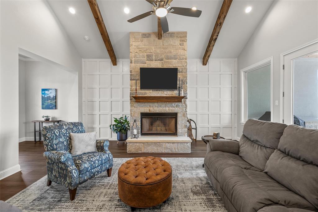 624 Lindsay Lane Robinson, TX 76706 - Photo 7 of 39 a living room with furniture a fireplace and a chandelier