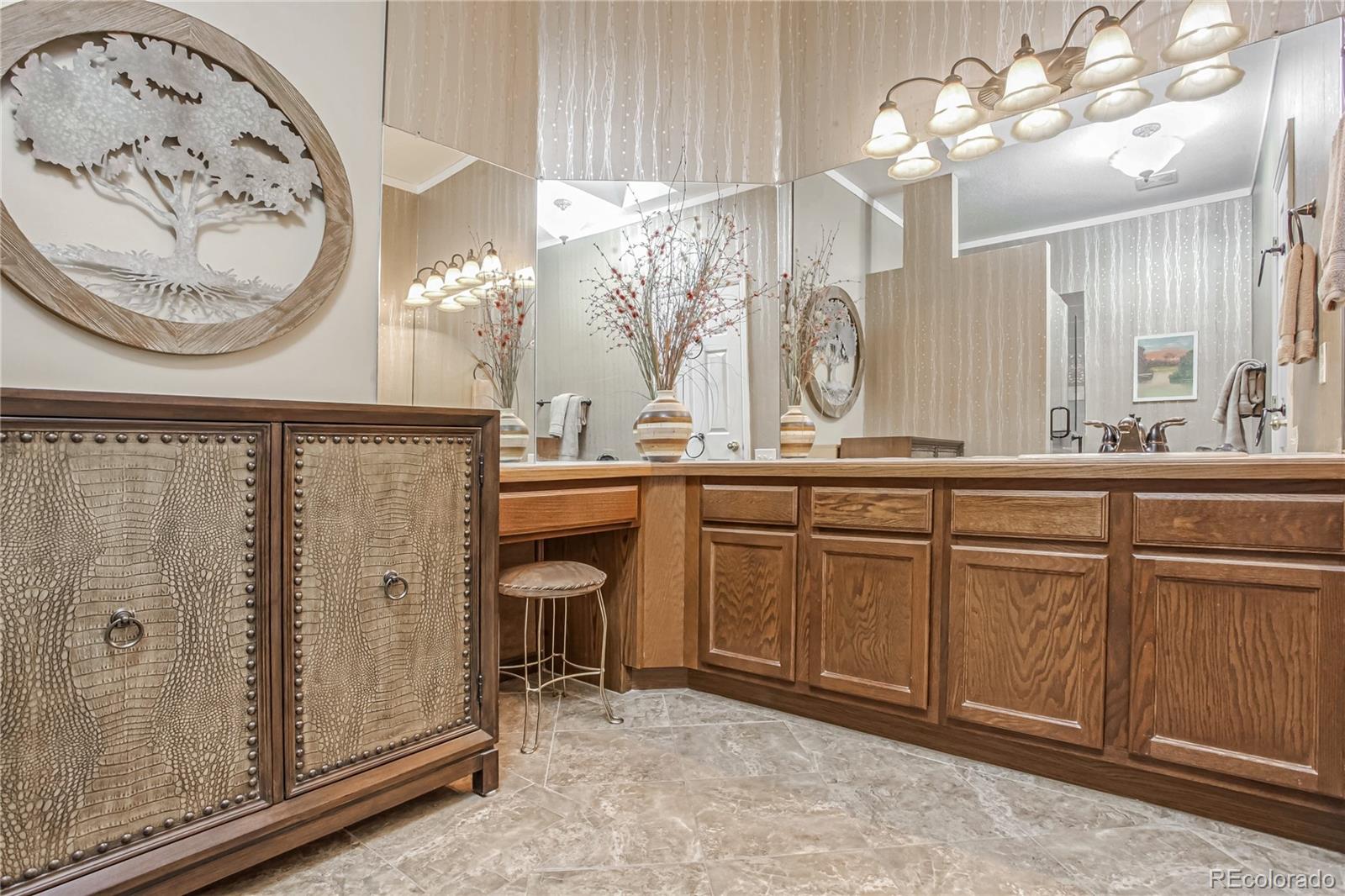 10106 North Grove Loop, Unit A Westminster, CO 80031 - Photo 14 of 33 a bathroom with a sink a mirror and a shower