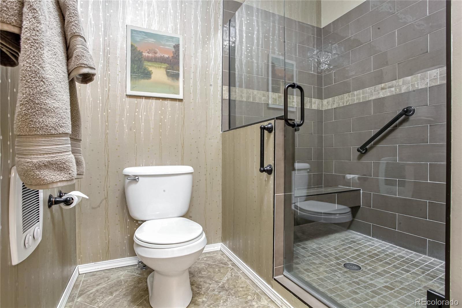 10106 North Grove Loop, Unit A Westminster, CO 80031 - Photo 15 of 33 a bathroom with a toilet and a shower