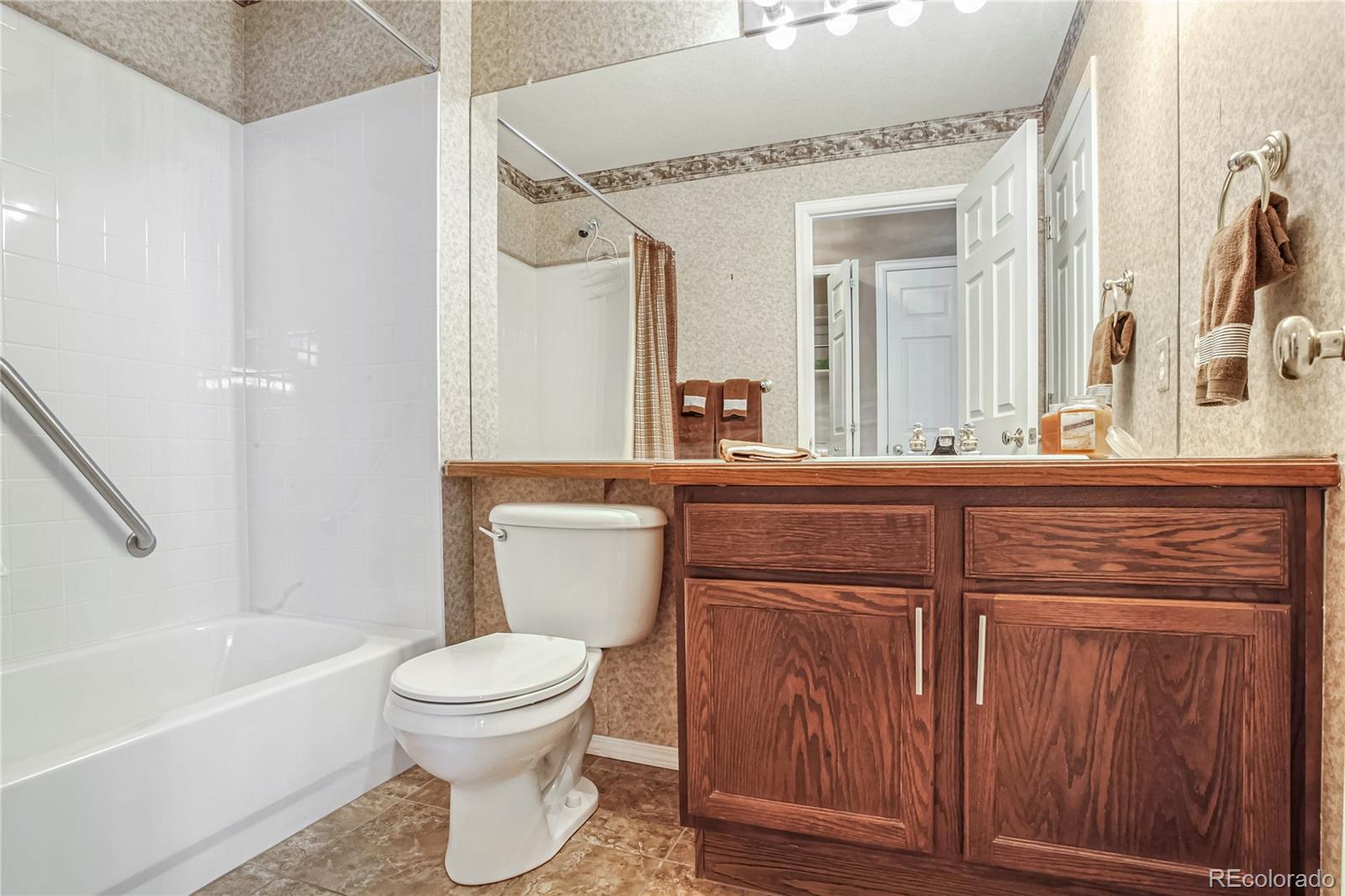 10106 North Grove Loop, Unit A Westminster, CO 80031 - Photo 20 of 33 a bathroom with a toilet a sink and a bathtub