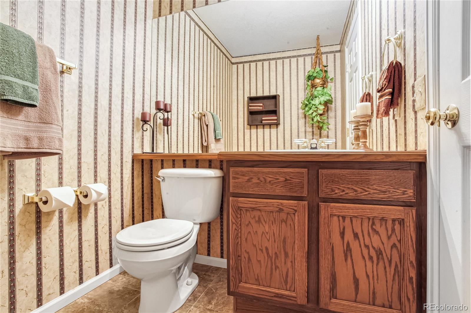 10106 North Grove Loop, Unit A Westminster, CO 80031 - Photo 23 of 33 a bathroom with a toilet a sink and a window
