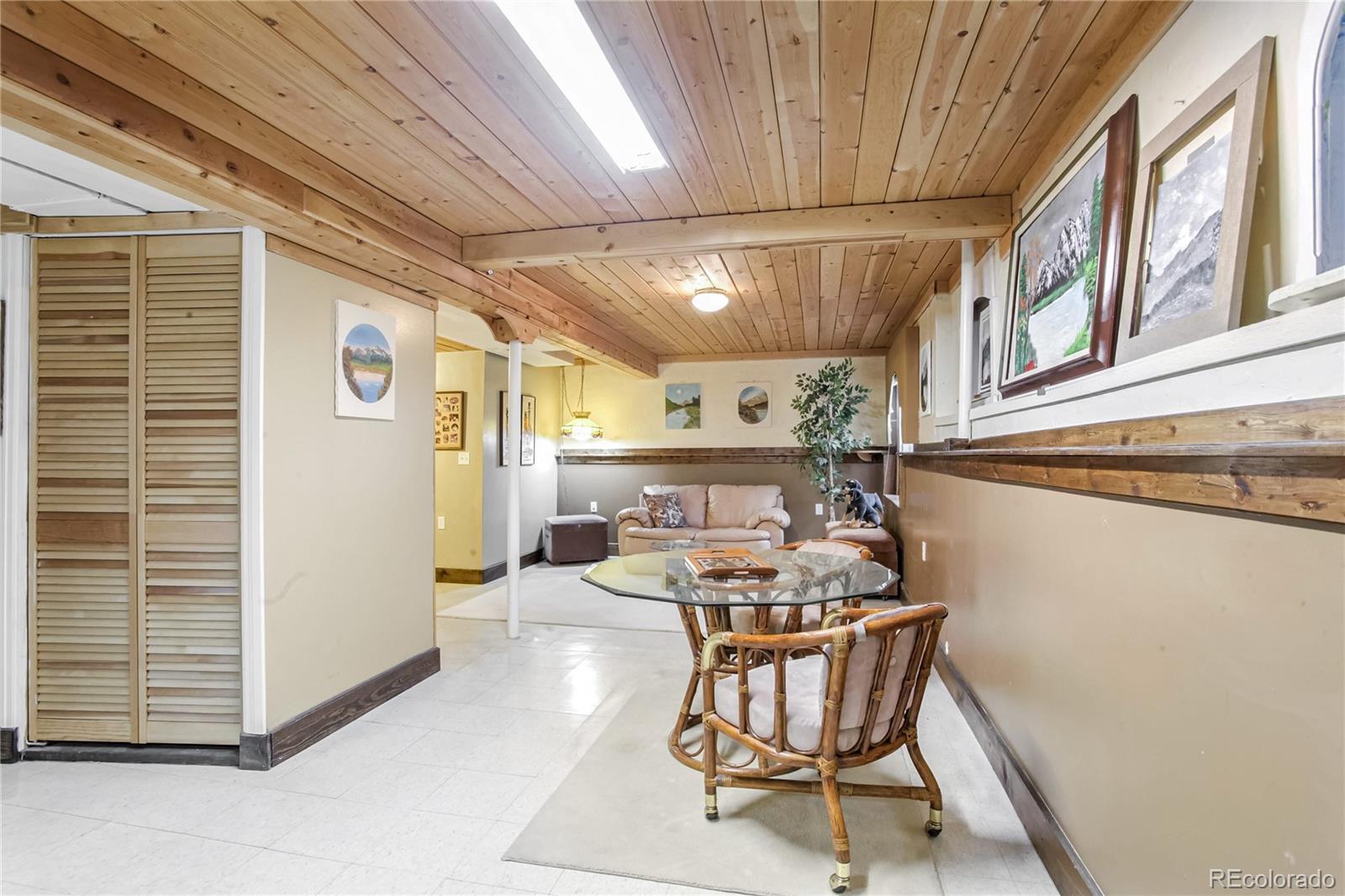 10106 North Grove Loop, Unit A Westminster, CO 80031 - Photo 24 of 33 a dining room with furniture and a chandelier