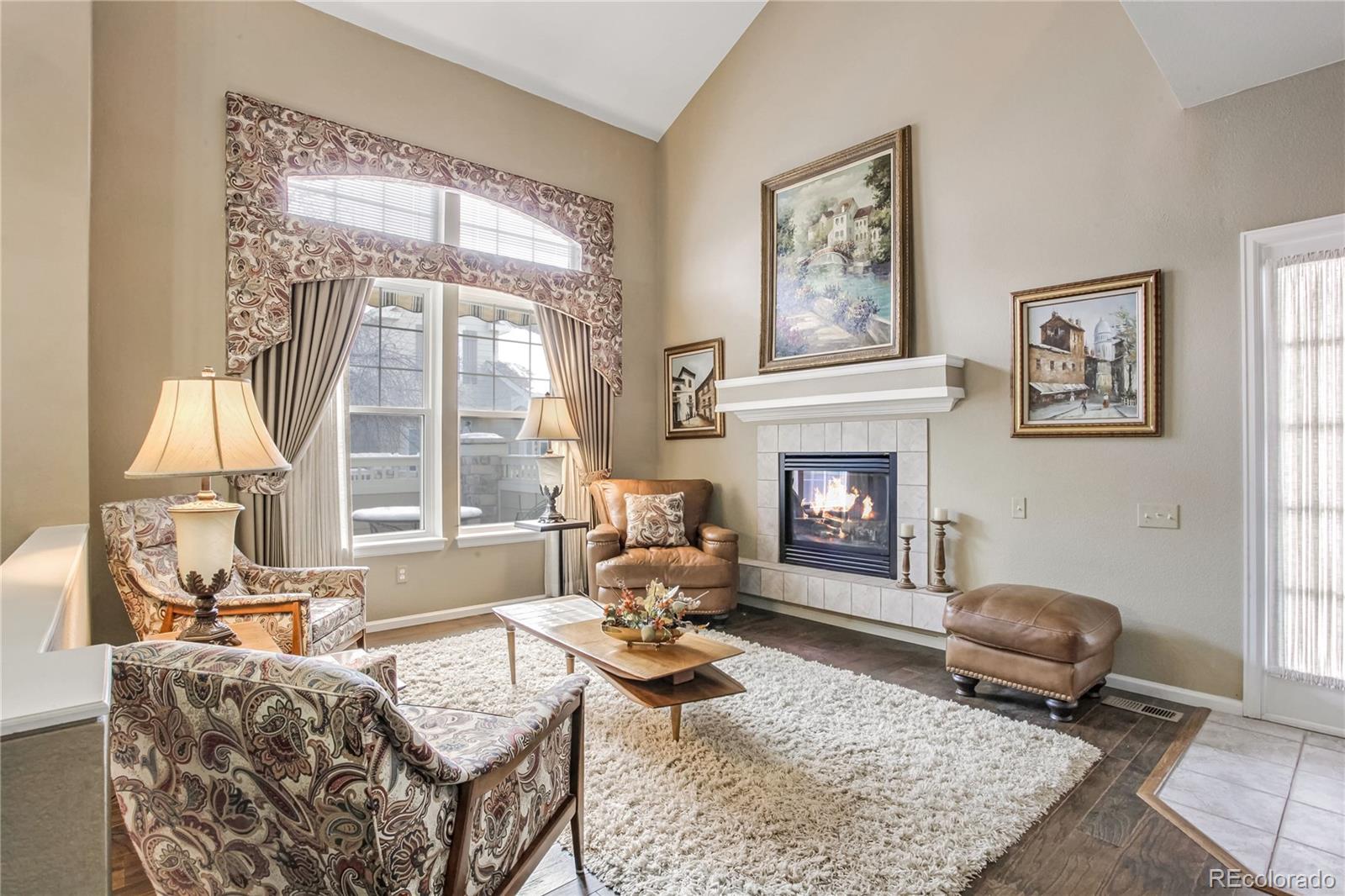 10106 North Grove Loop, Unit A Westminster, CO 80031 - Photo 5 of 33 a living room with furniture large window and a fireplace