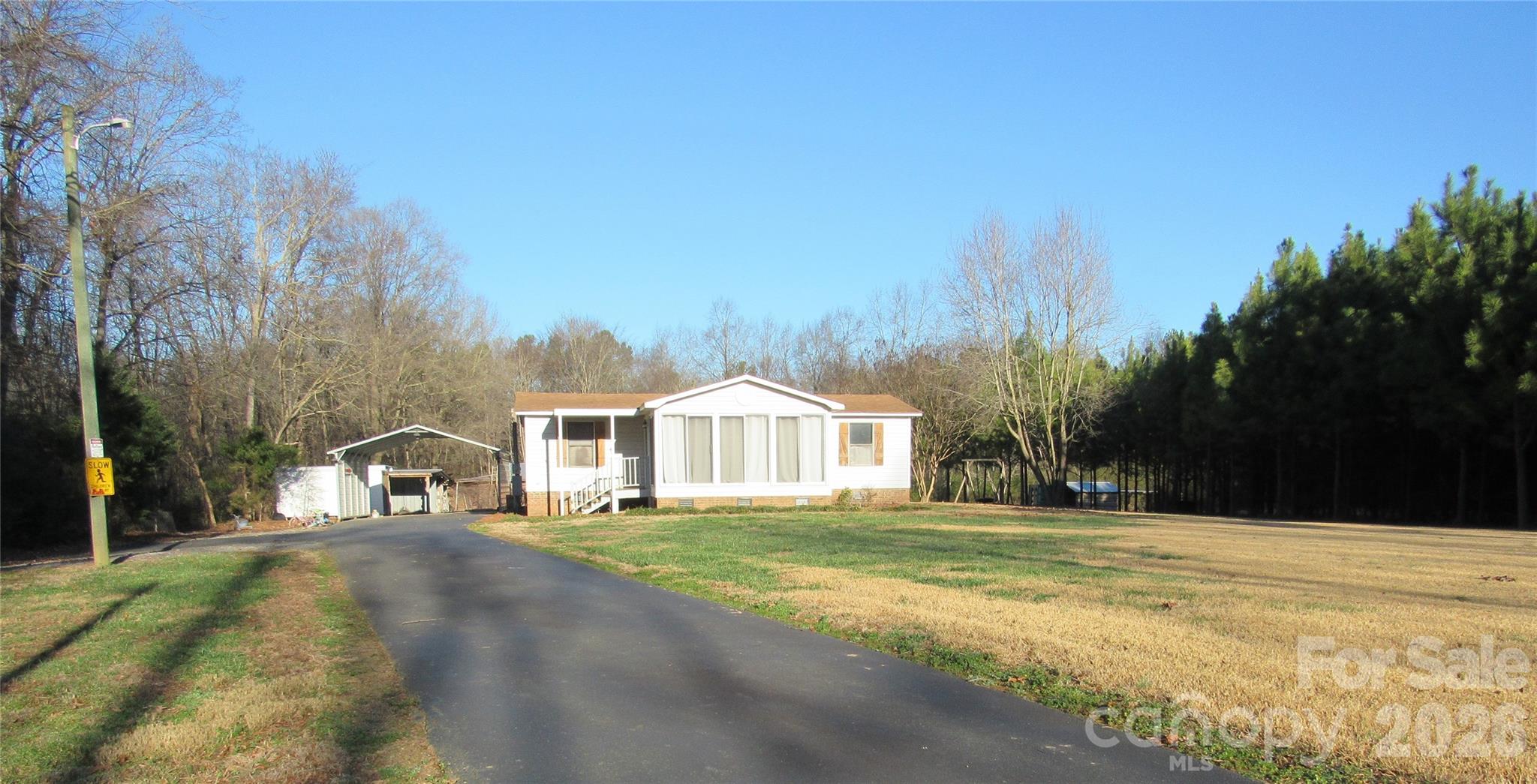 6825 Nance-Tarlton Road Marshville, NC 28103 - Photo 1 of 34 a front view of a house with a yard