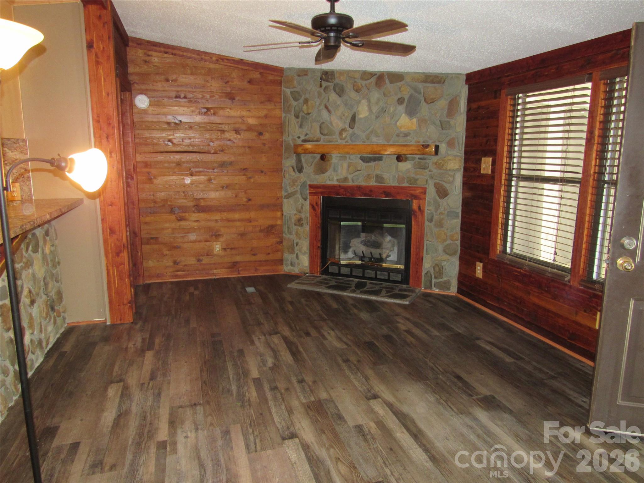 6825 Nance-Tarlton Road Marshville, NC 28103 - Photo 15 of 34 a view of empty room with wooden floor and fireplace