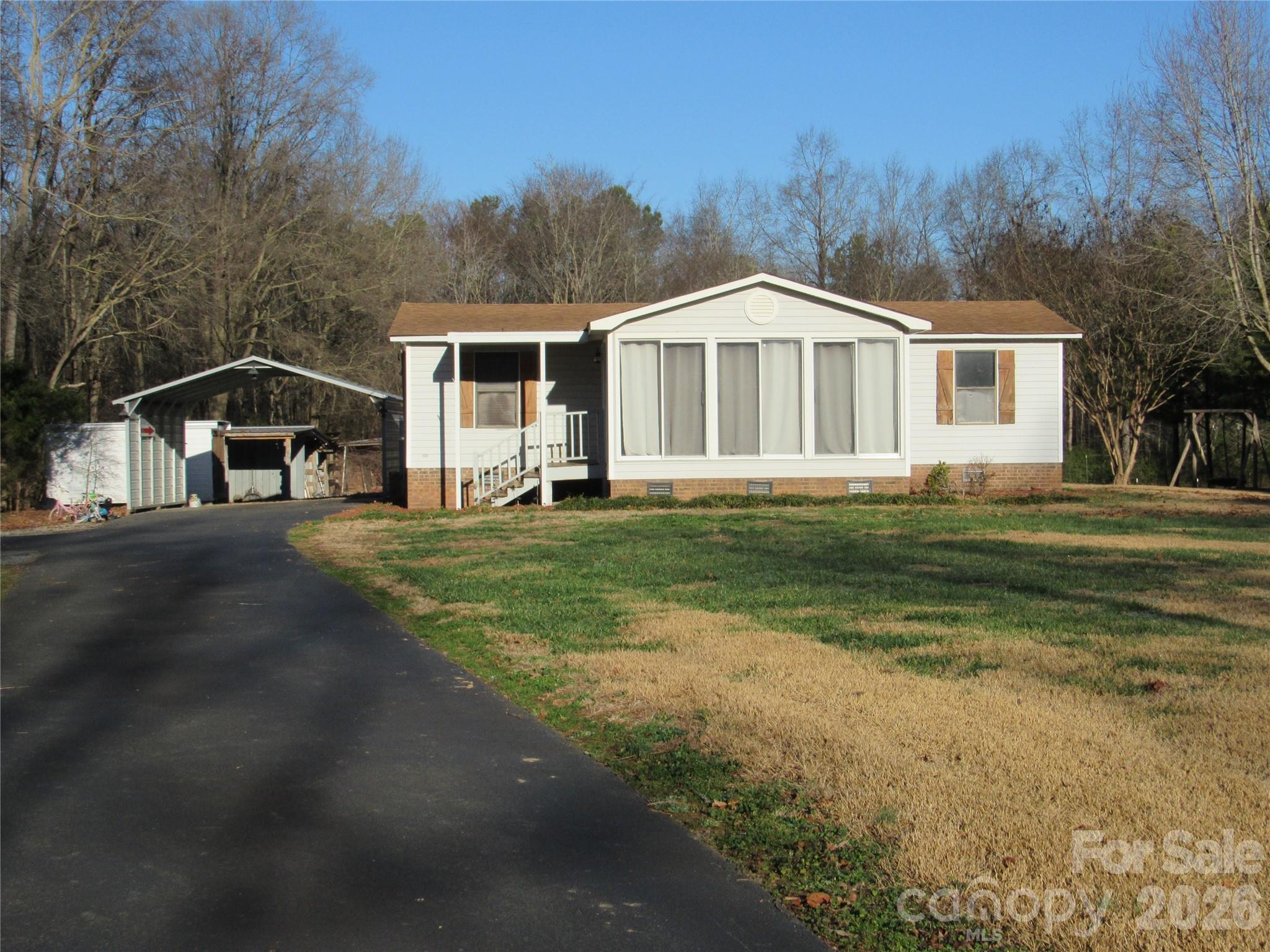 6825 Nance-Tarlton Road Marshville, NC 28103 - Photo 2 of 34 a front view of a house with a yard
