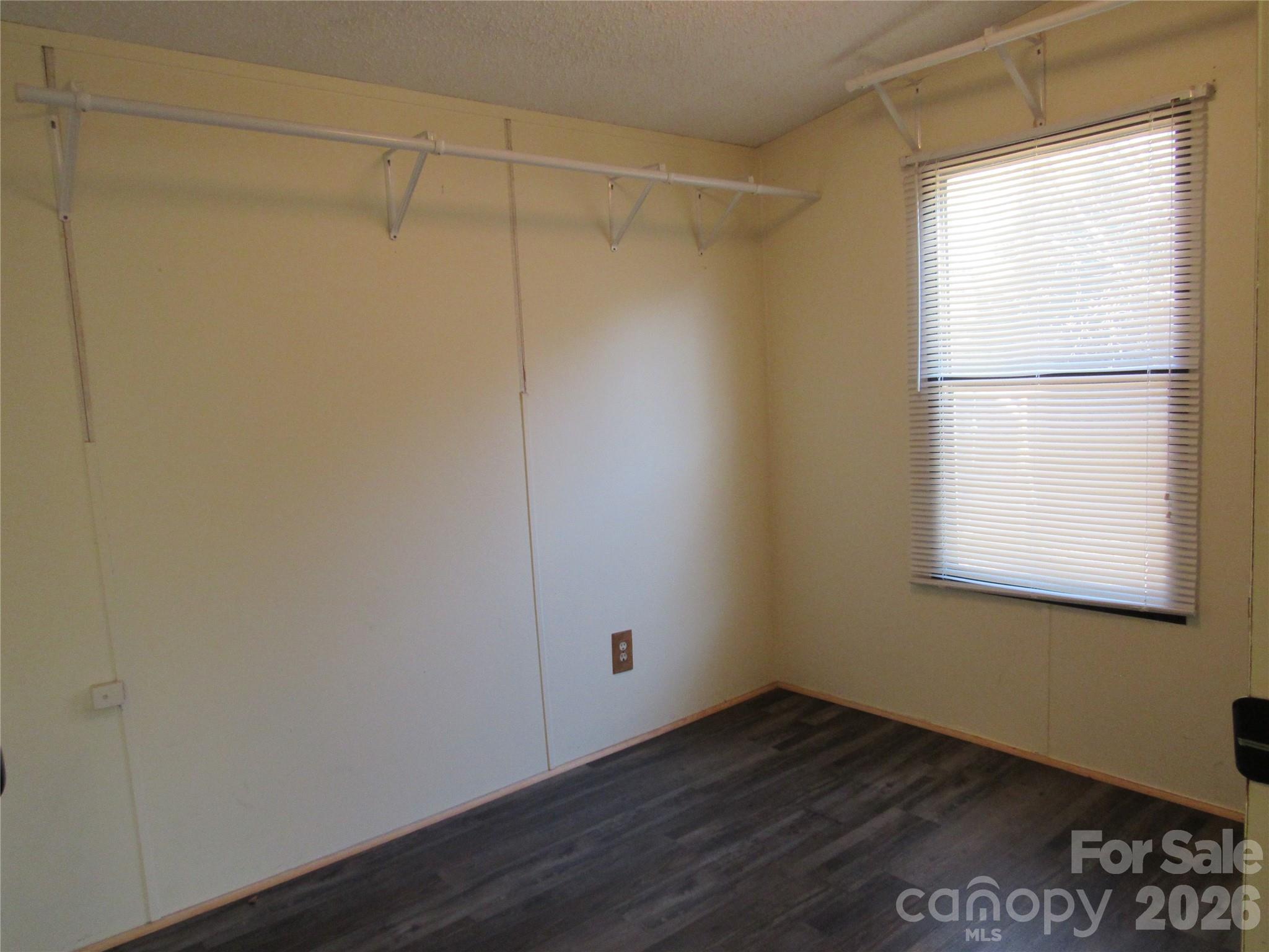 6825 Nance-Tarlton Road Marshville, NC 28103 - Photo 28 of 34 a view of an empty room with wooden floor and a window