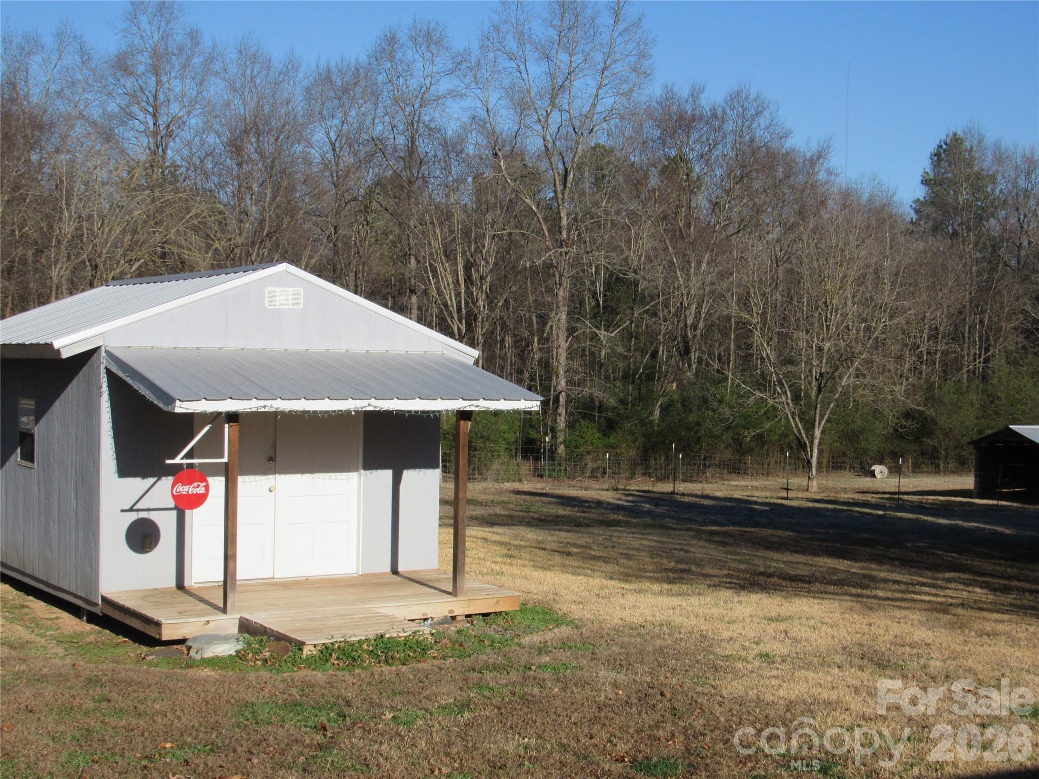 6825 Nance-Tarlton Road Marshville, NC 28103 - Photo 5 of 34 a side view of a house with a yard and garage