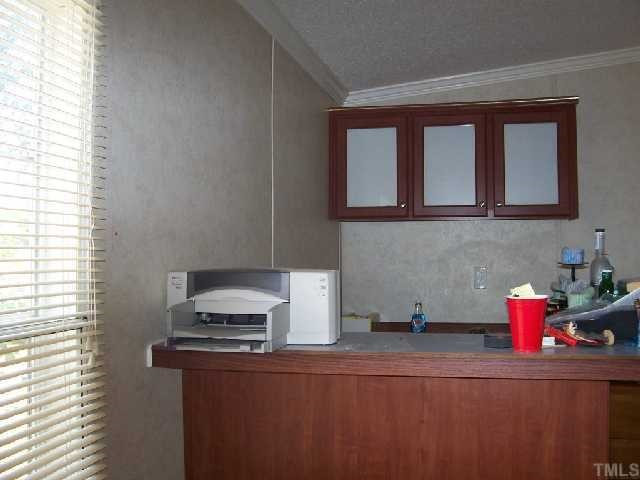 730 Creech Johnson Road Zebulon, NC 27597 - Photo 11 of 12 Huge den with bar & extra cabinets. This is the entertainment room! Den/Family/Great Room