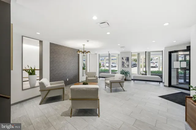 a living room with furniture and large windows