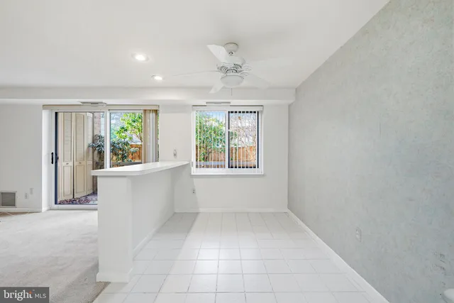 an empty room with windows and outdoor view
