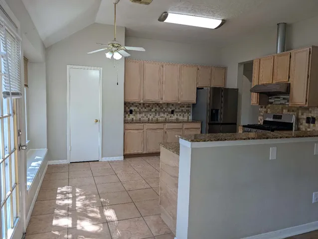a kitchen with stainless steel appliances a refrigerator sink and microwave