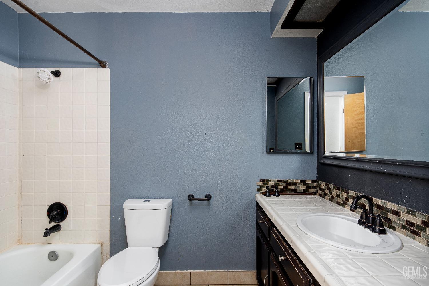 Undisclosed Address Bakersfield, CA 93313 - Photo 12 of 17 a bathroom with a granite countertop sink mirror vanity and toilet
