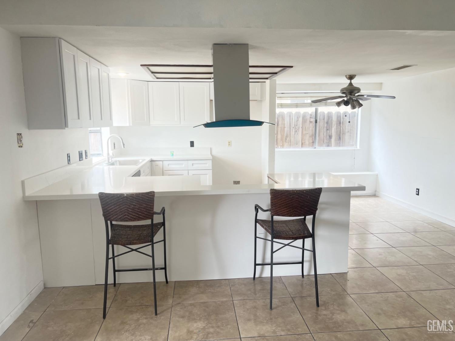 Undisclosed Address Bakersfield, CA 93313 - Photo 5 of 17 a kitchen with a cabinets and chairs in it