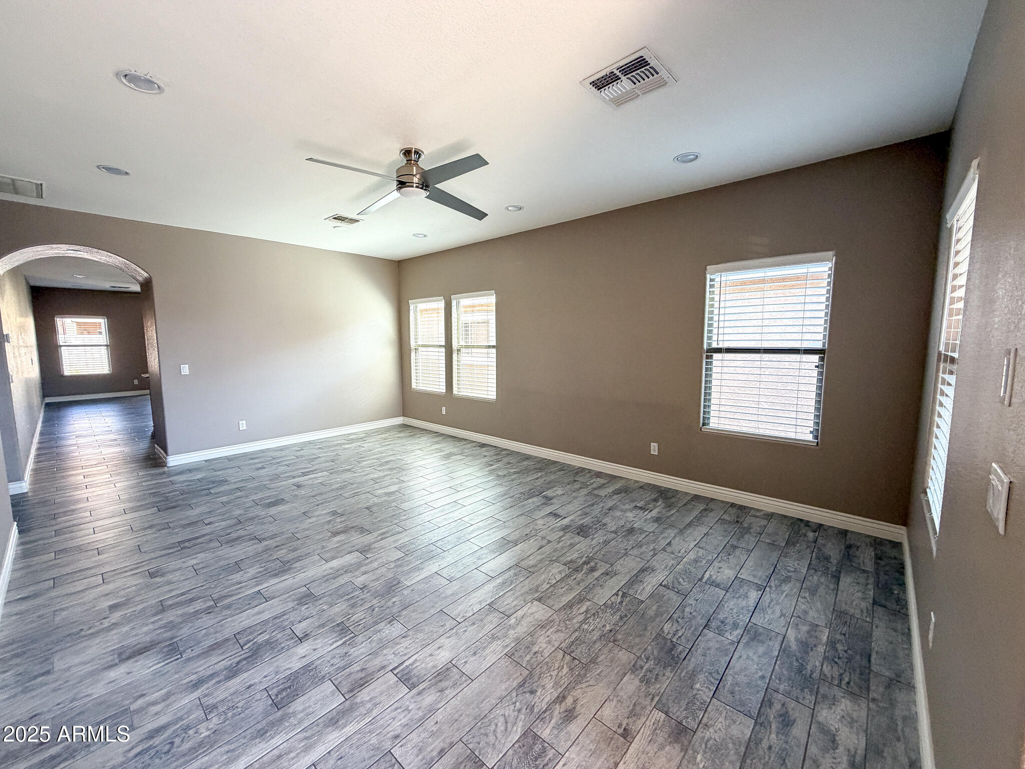 982 East Doris Street Avondale, AZ 85323 - Photo 3 of 17 wooden floor in an empty room with a window