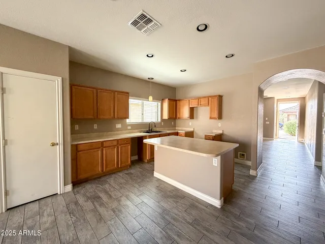 a large white kitchen with a large window