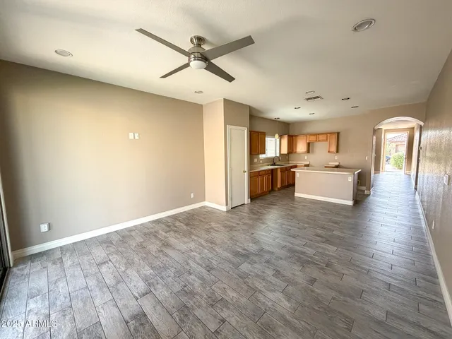 a view of a livingroom with hardwood floor and a ceiling fan