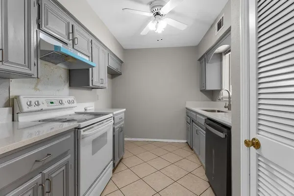 a kitchen with stainless steel appliances granite countertop a stove and a sink