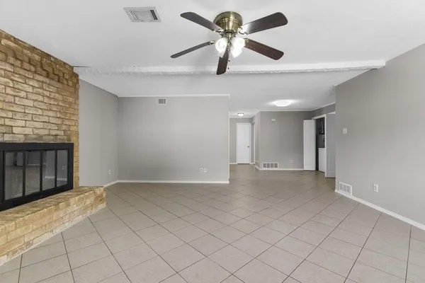 a view of a livingroom with a ceiling fan and window