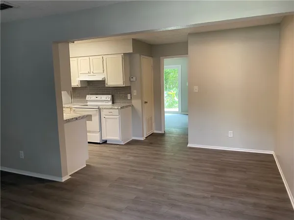 a view of a kitchen with wooden floor and a sink