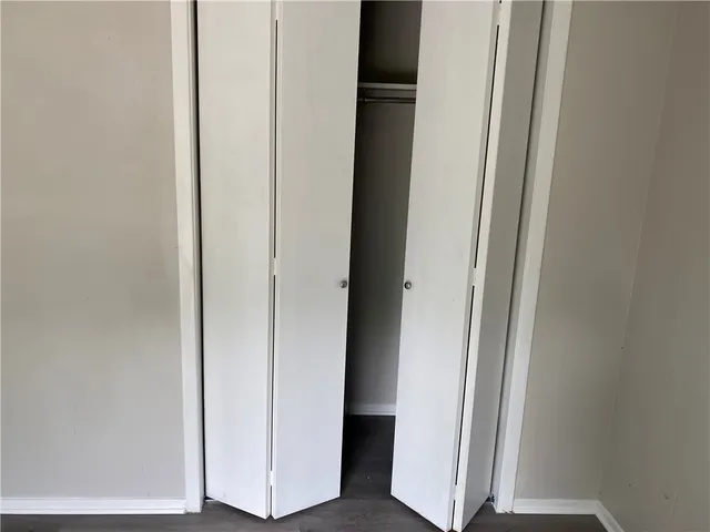 a view of a closet with wooden floor