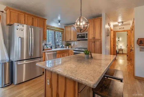 a kitchen with stainless steel appliances granite countertop counter space a refrigerator and cabinets