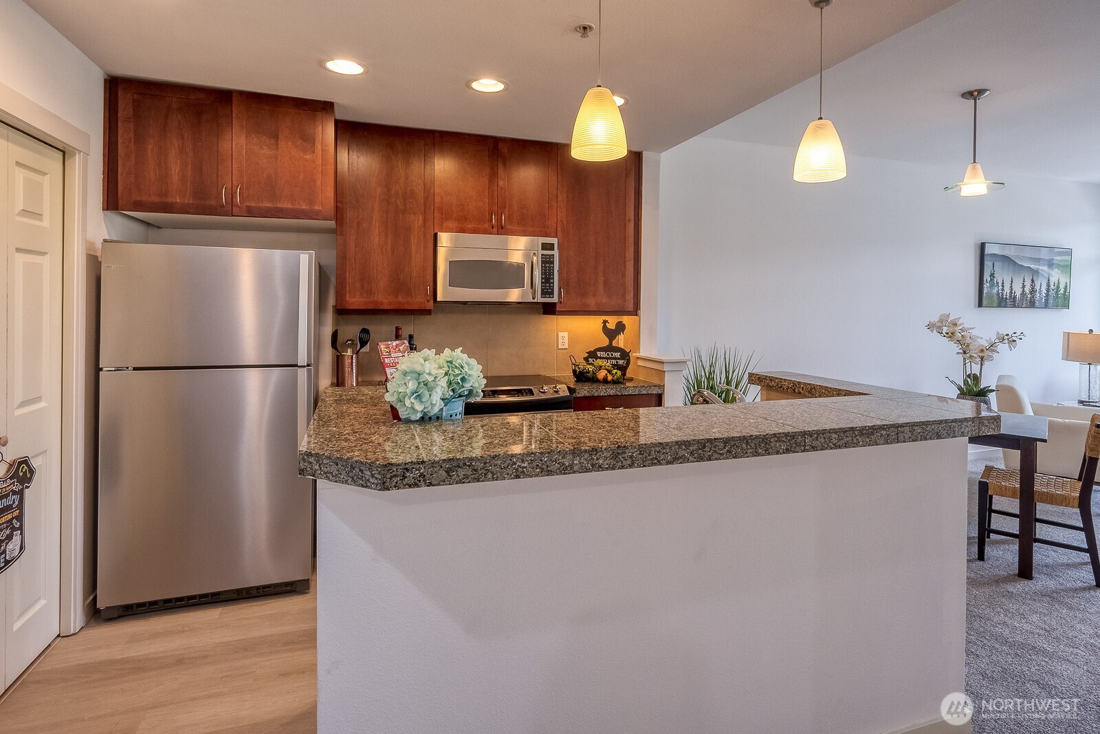 16141 Cleveland Street, Unit 412 Redmond, WA 98052 - Photo 18 of 31 a kitchen with granite countertop a refrigerator and a sink