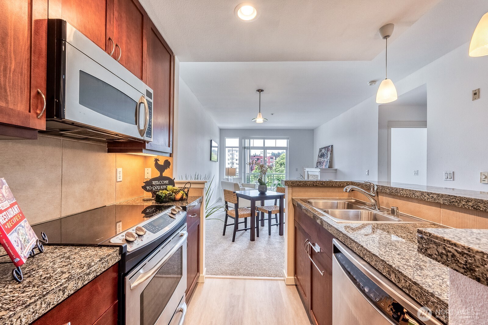 16141 Cleveland Street, Unit 412 Redmond, WA 98052 - Photo 21 of 31 a kitchen with stove cabinets and living room