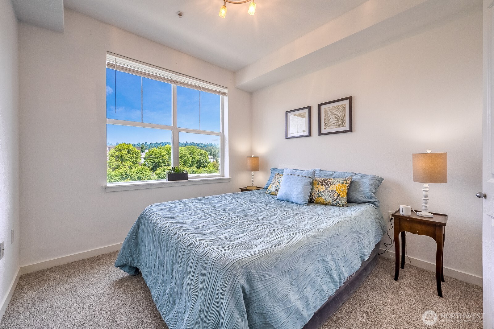 16141 Cleveland Street, Unit 412 Redmond, WA 98052 - Photo 22 of 31 a bedroom with a bed and a window