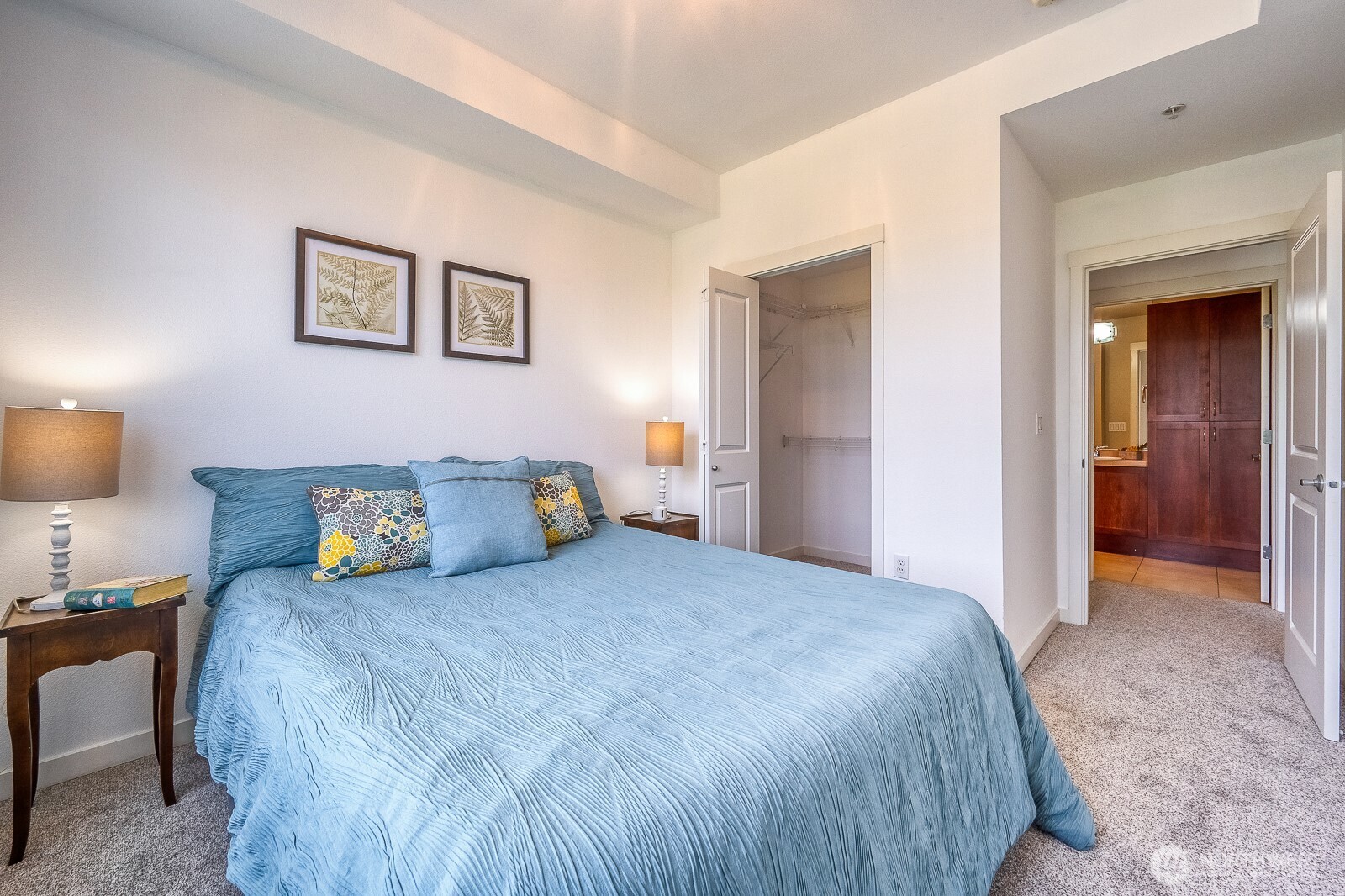 16141 Cleveland Street, Unit 412 Redmond, WA 98052 - Photo 23 of 31 a bedroom with a bed and a lamp