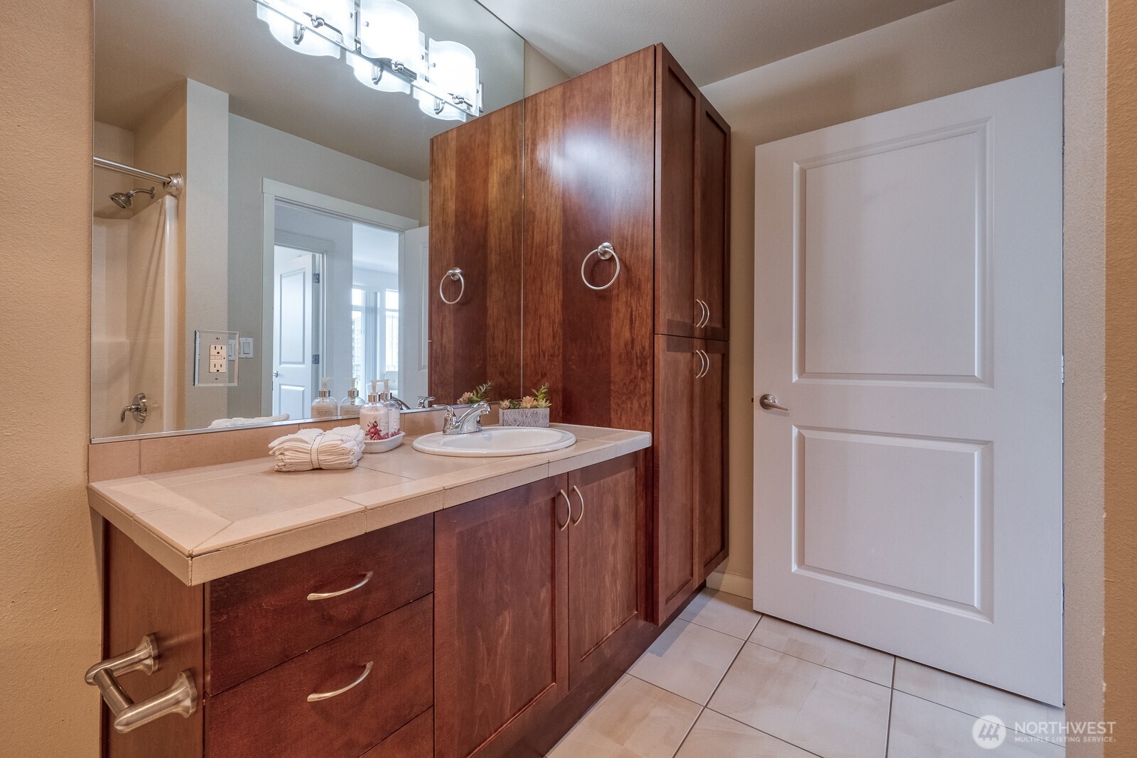 16141 Cleveland Street, Unit 412 Redmond, WA 98052 - Photo 25 of 31 a bathroom with a sink and a mirror
