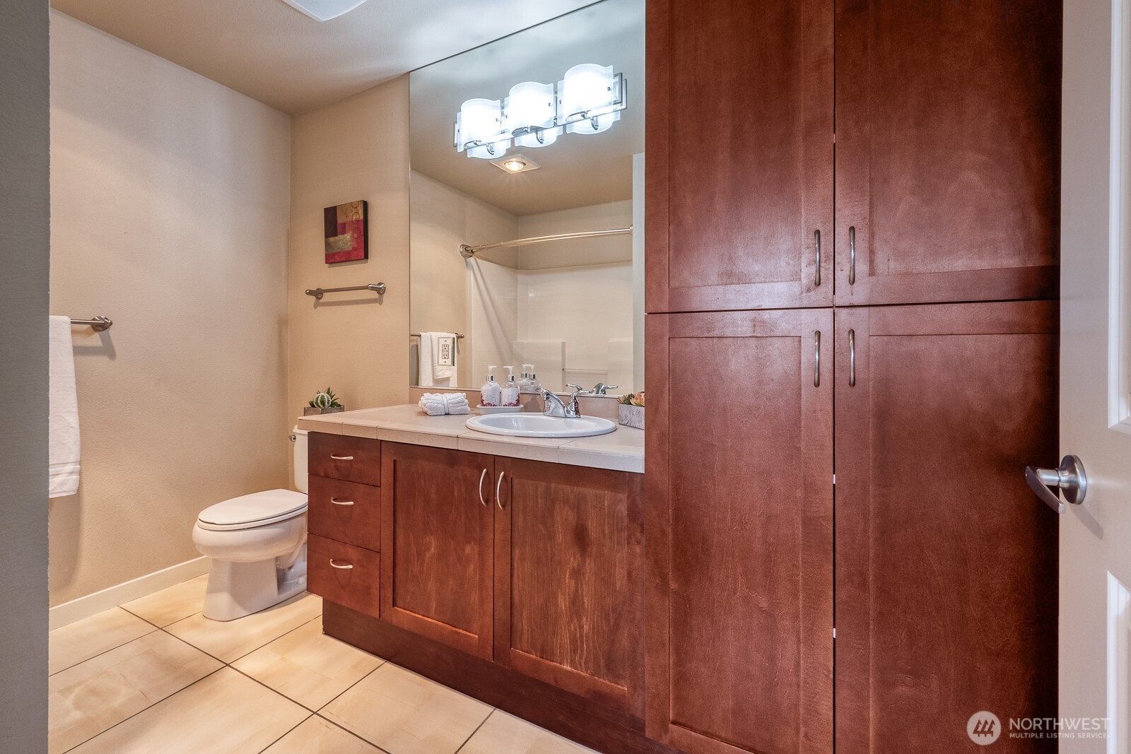 16141 Cleveland Street, Unit 412 Redmond, WA 98052 - Photo 26 of 31 a bathroom with a sink a toilet and shower
