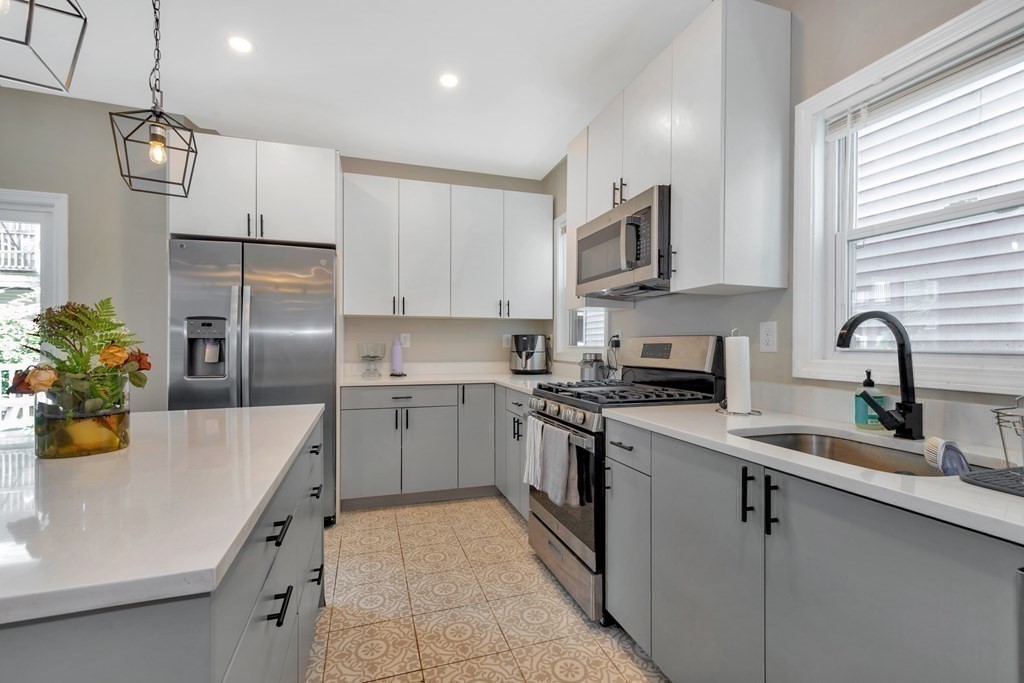 a kitchen with a sink stainless steel appliances and cabinets