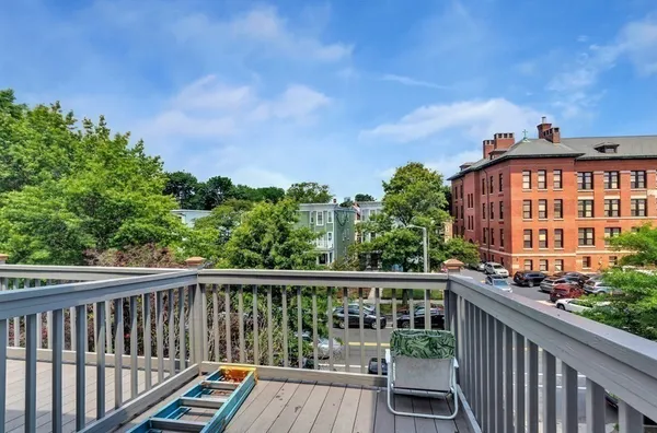 a view of a roof deck with wooden fence and floor
