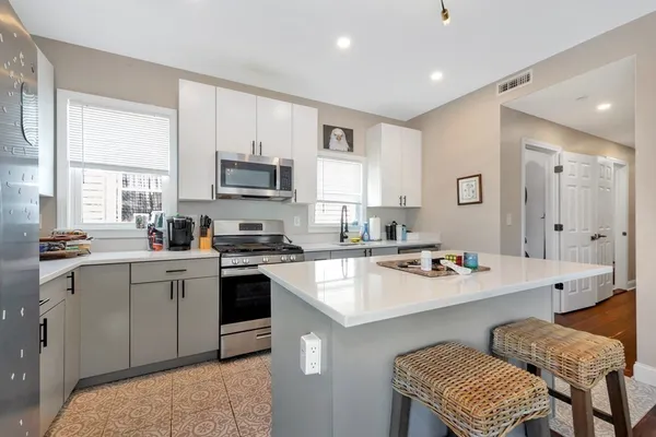 a kitchen with a sink stove top oven and refrigerator