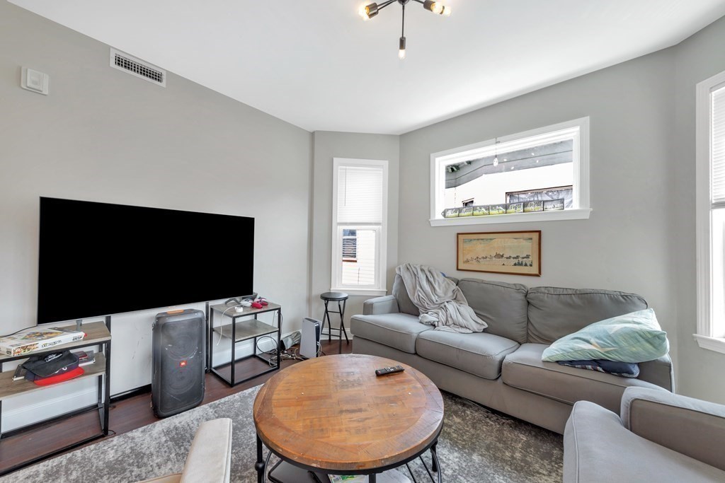 777 Columbia Road, Unit 2 Boston, MA 02125 - Photo 19 of 21 a living room with furniture and a flat screen tv