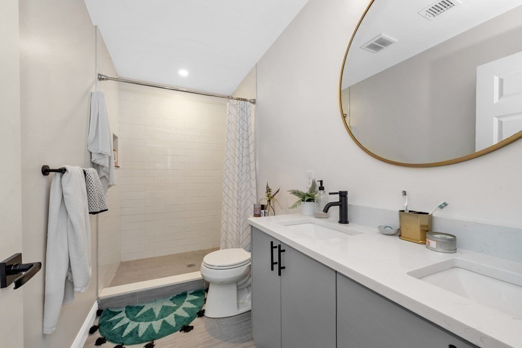 777 Columbia Road, Unit 2 Boston, MA 02125 - Photo 20 of 21 a bathroom with a sink a toilet and shower