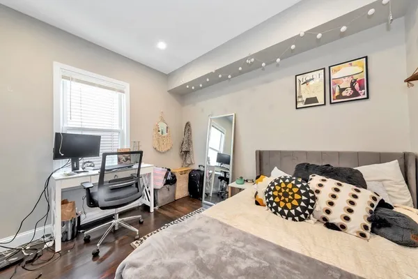 a bedroom with a bed and a chair