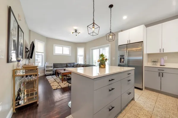 a kitchen with stainless steel appliances granite countertop a sink refrigerator and cabinets