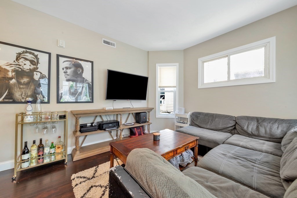777 Columbia Road, Unit 2 Boston, MA 02125 - Photo 6 of 21 a living room with furniture and a flat screen tv