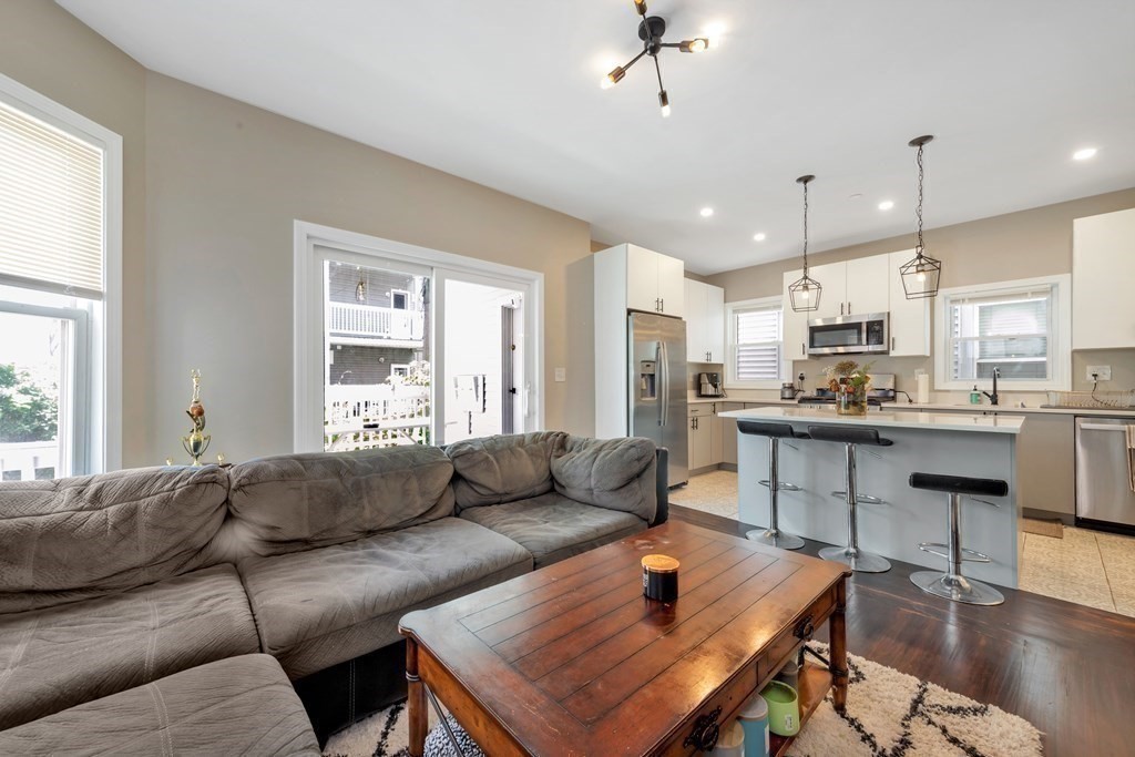 777 Columbia Road, Unit 2 Boston, MA 02125 - Photo 7 of 21 a living room with furniture and kitchen view