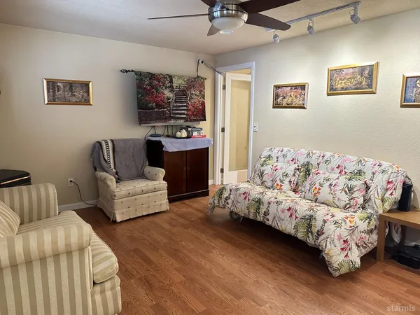 a living room with furniture and painting on the wall