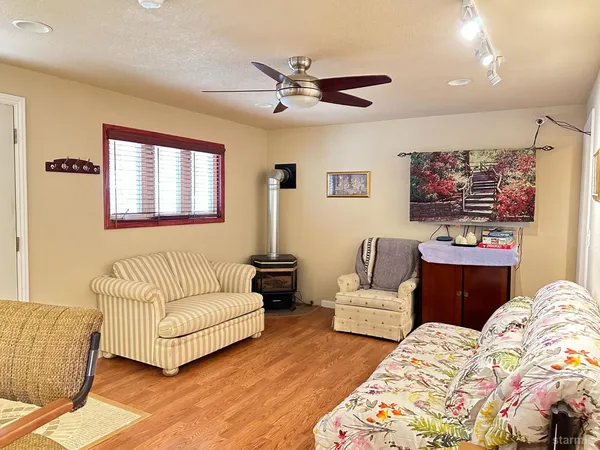 a living room with furniture and wall paintings