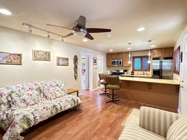 a living room with furniture and kitchen view