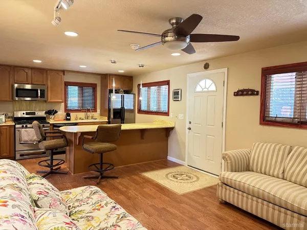 a living room with furniture and a wooden floor