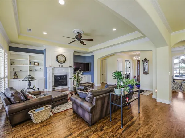 a living room with furniture a fireplace and a large window